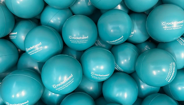 An image of many blue stress balls with Rocketseed logo and text "Squeeze the stress out of email signatures"